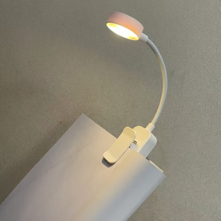 portable LED reading light clipped on book for night reading